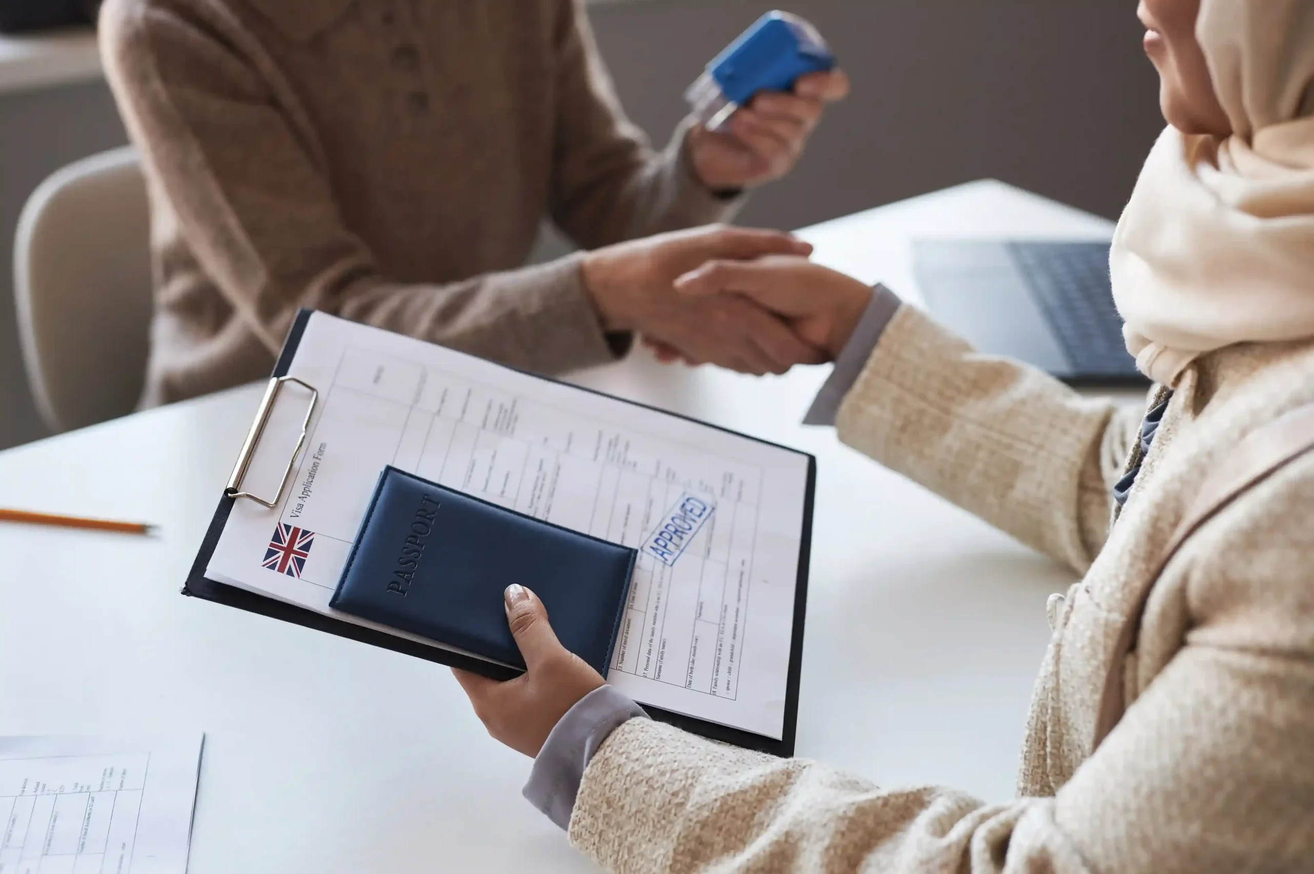closeup-approved-visa-application-form-passport-hand-applicant_11zon_11zon